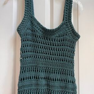 Sleeveless crochet dress in a teal color.